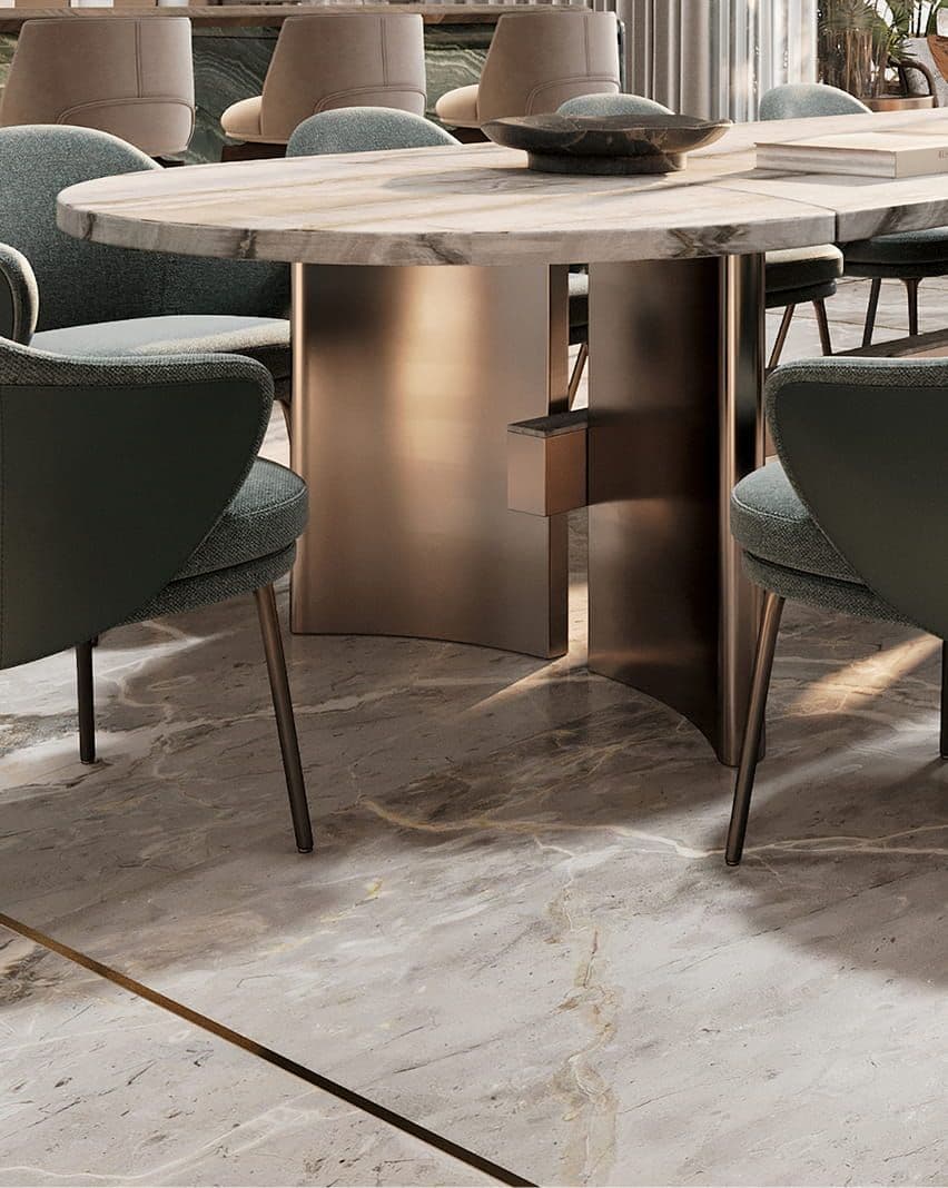 Elegant modern dining area with an oval table, metallic base, and dark green upholstered chairs.