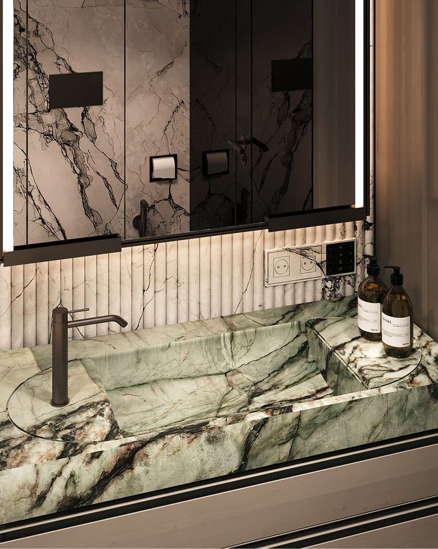 Modern bathroom with a green marble sink countertop and a sleek dark faucet.