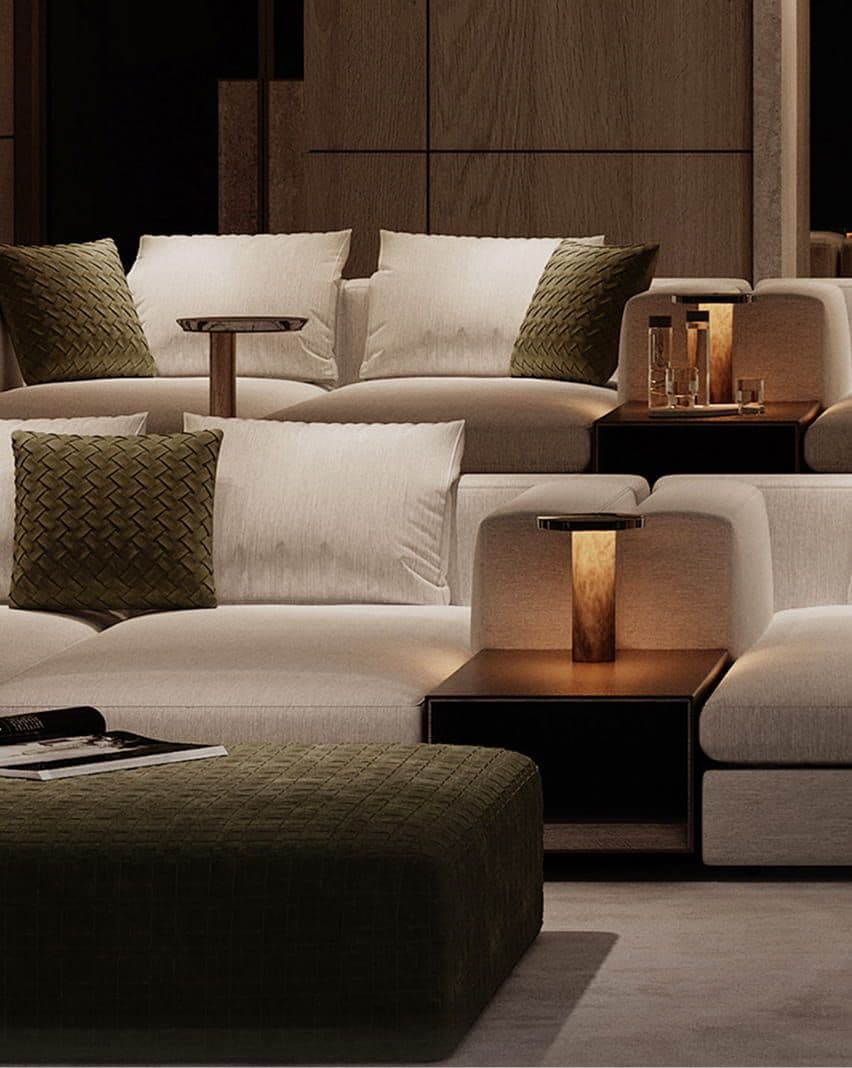 Luxurious light beige sectional sofa with olive green accents, integrated tables, and elegant lighting.